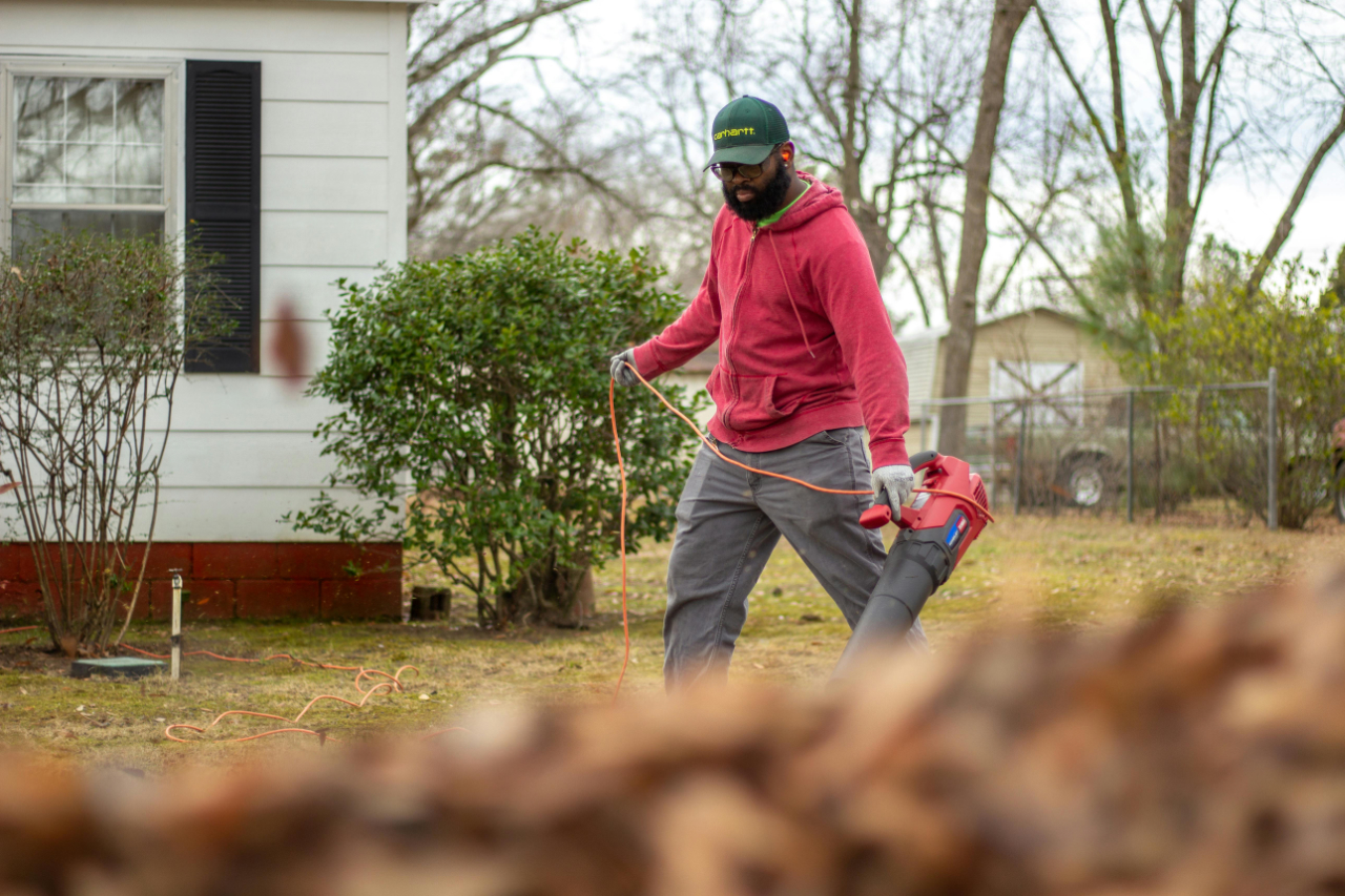man blowing leaves